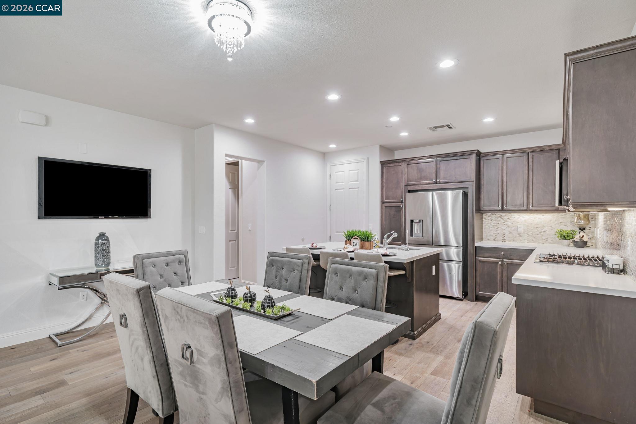 6260 Main Branch Road San Ramon, CA 94582 - Photo 7 of 38 a kitchen with stainless steel appliances kitchen island granite countertop a sink a stove a refrigerator a microwave with island and chairs