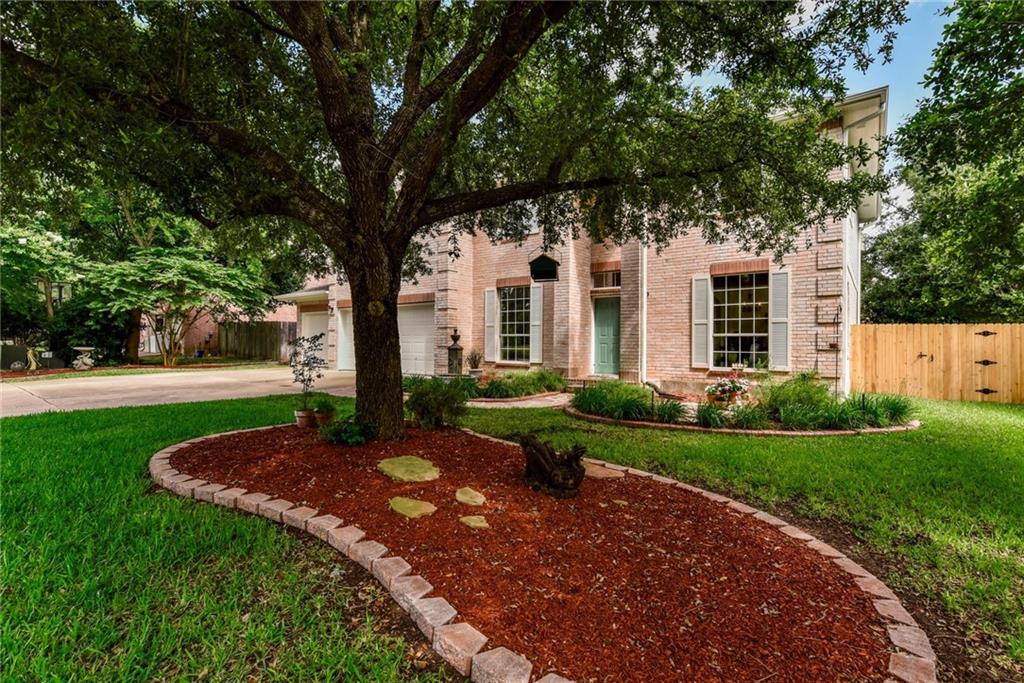 455 Logan Road Georgetown, TX 78628 - Photo 3 of 35 Mature trees and neat landscaping frame this inviting brick facade.