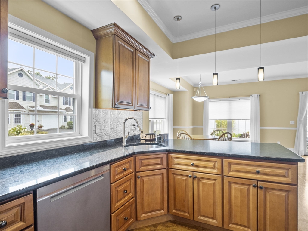 170 Beach Road, Unit 52 Salisbury, MA 01952 - Photo 11 of 34 a kitchen with stainless steel appliances granite countertop a sink a stove and cabinets
