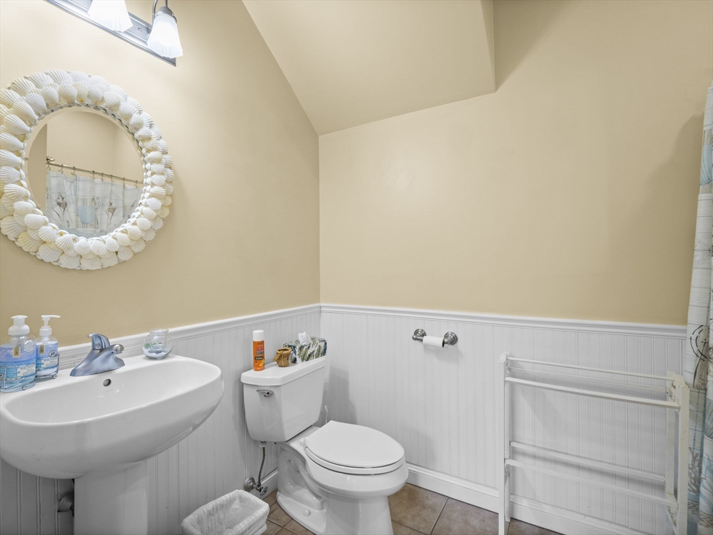 170 Beach Road, Unit 52 Salisbury, MA 01952 - Photo 16 of 34 a bathroom with a sink mirror and toilet