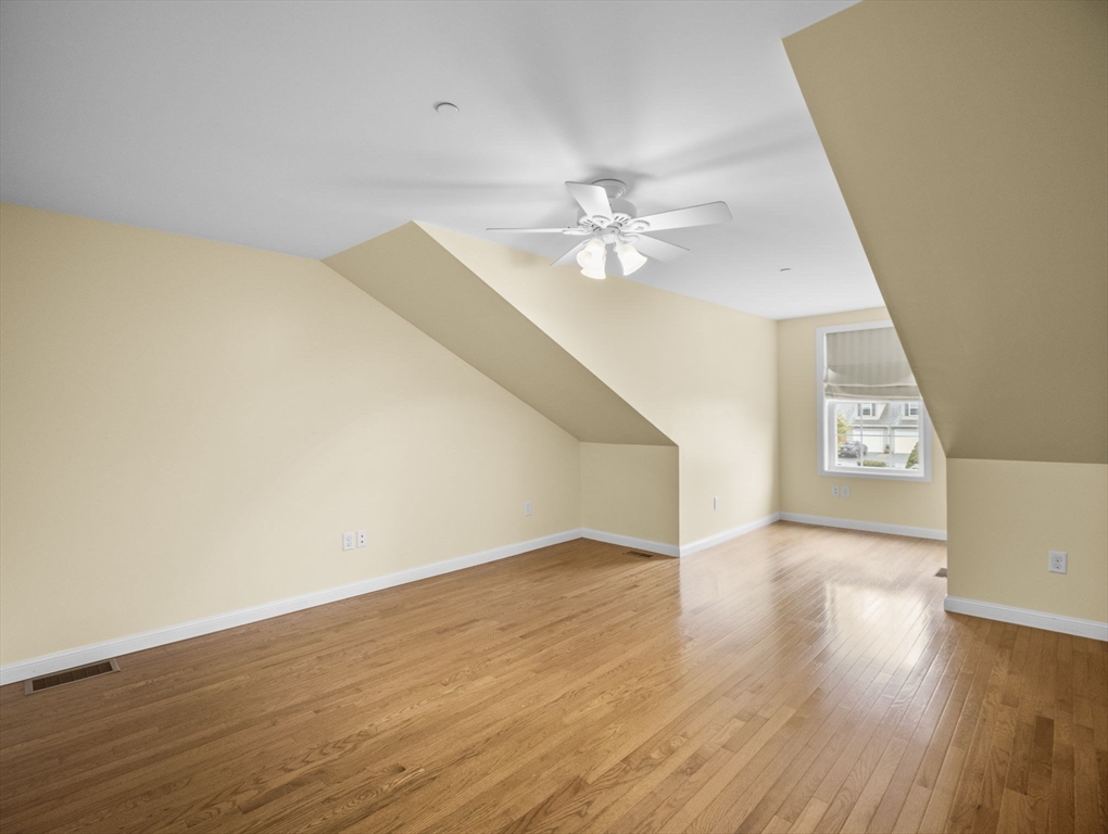 170 Beach Road, Unit 52 Salisbury, MA 01952 - Photo 20 of 34 an empty room with wooden floor and ceiling fan
