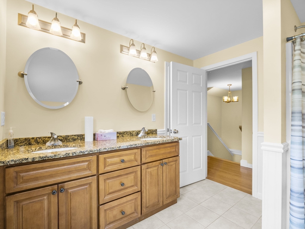 170 Beach Road, Unit 52 Salisbury, MA 01952 - Photo 23 of 34 a bathroom with a double vanity sink and a mirror