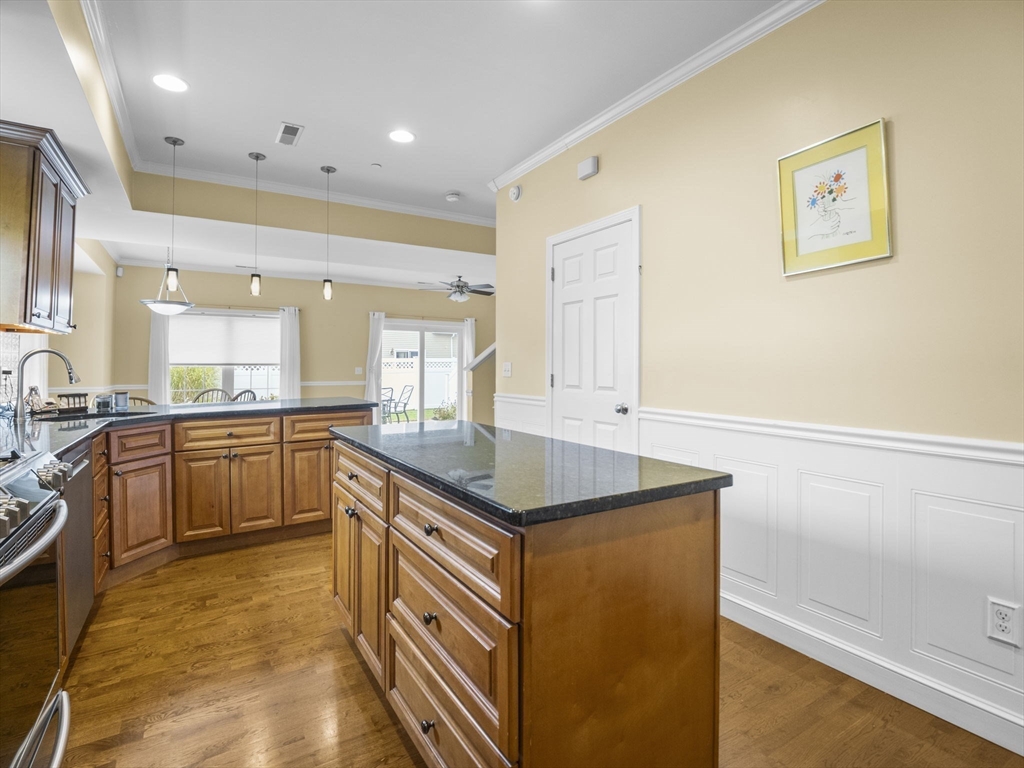 170 Beach Road, Unit 52 Salisbury, MA 01952 - Photo 6 of 34 a kitchen with granite countertop a sink and cabinets