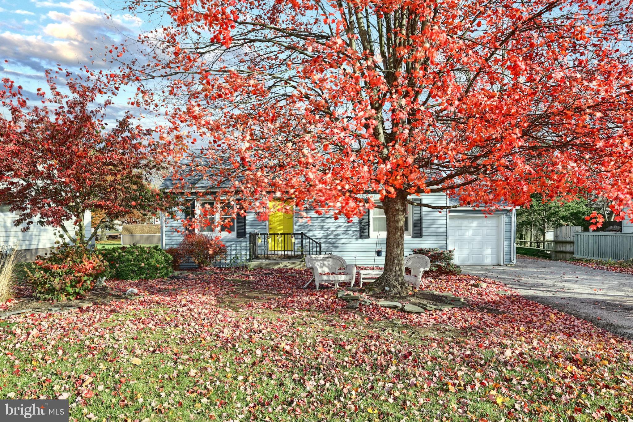 a backyard of a house with table and chairs