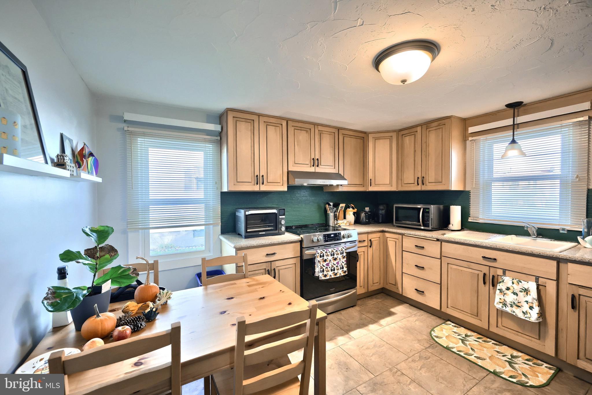 34 Redding Lane Gettysburg, PA 17325 - Photo 19 of 40 a kitchen with stainless steel appliances granite countertop a stove top oven a sink a dining table and chairs with wooden floor