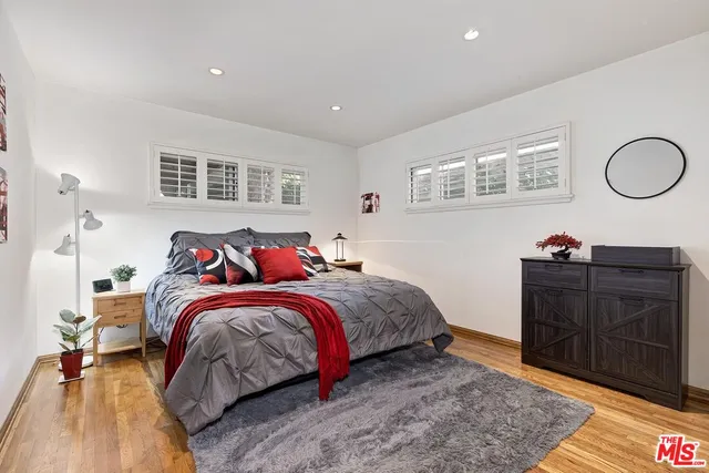 a bed room with a bed and dresser