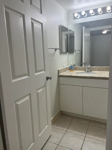 a bathroom with a sink a toilet and mirror