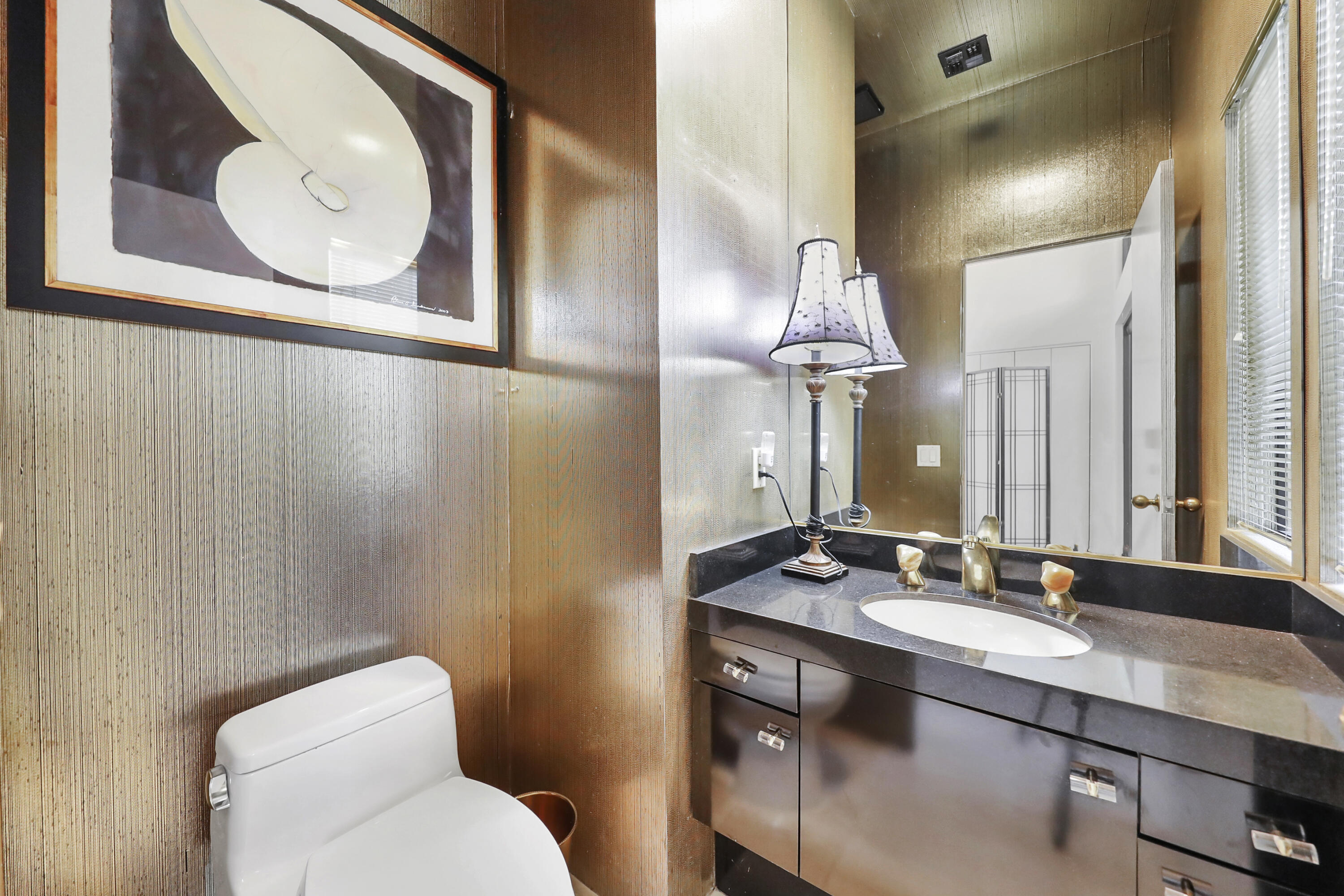 43721 Port Maria Road Bermuda Dunes, CA 92203 - Photo 12 of 37 a bathroom with a granite countertop sink mirror and toilet