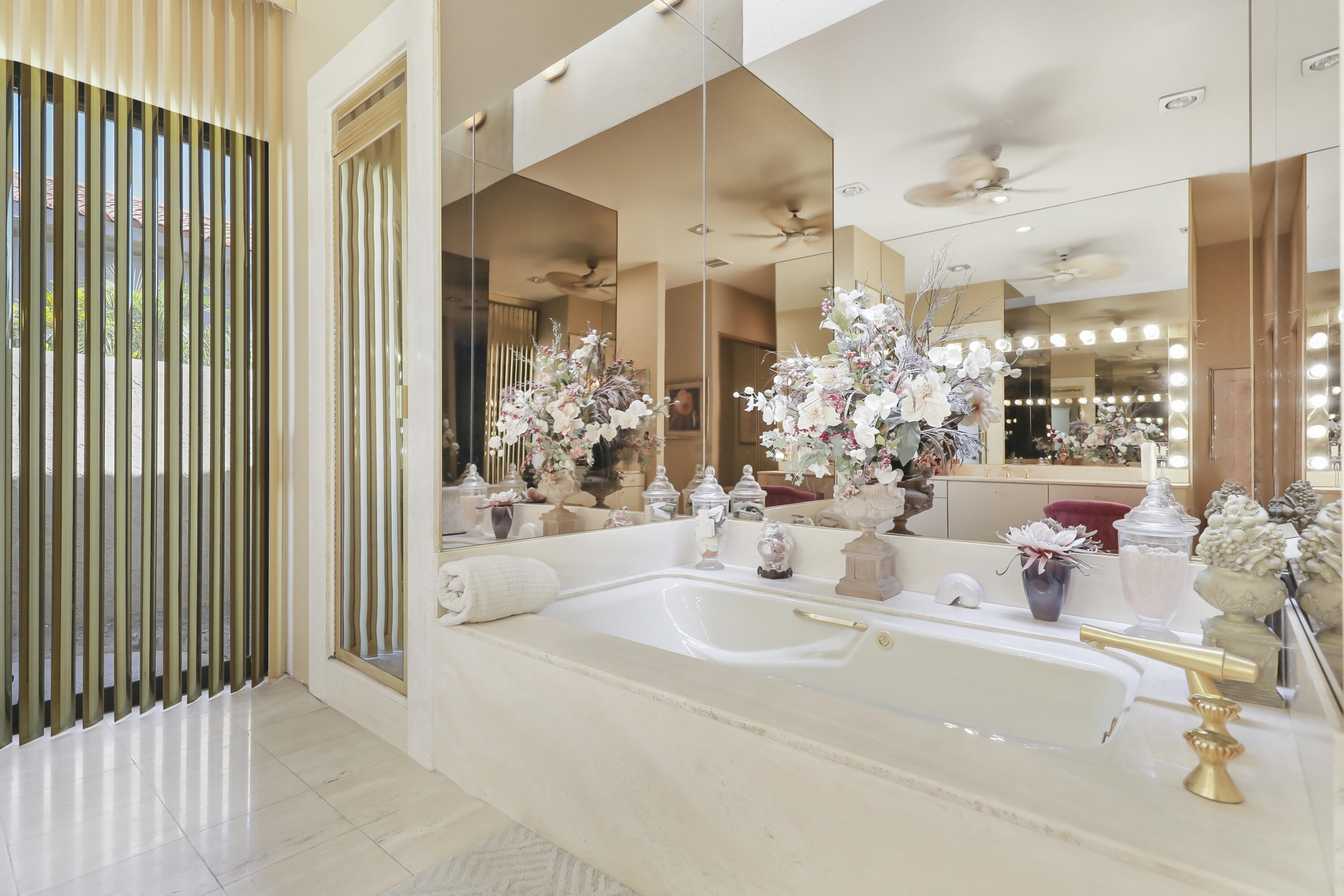 43721 Port Maria Road Bermuda Dunes, CA 92203 - Photo 16 of 37 a bathroom with a tub sink and mirror
