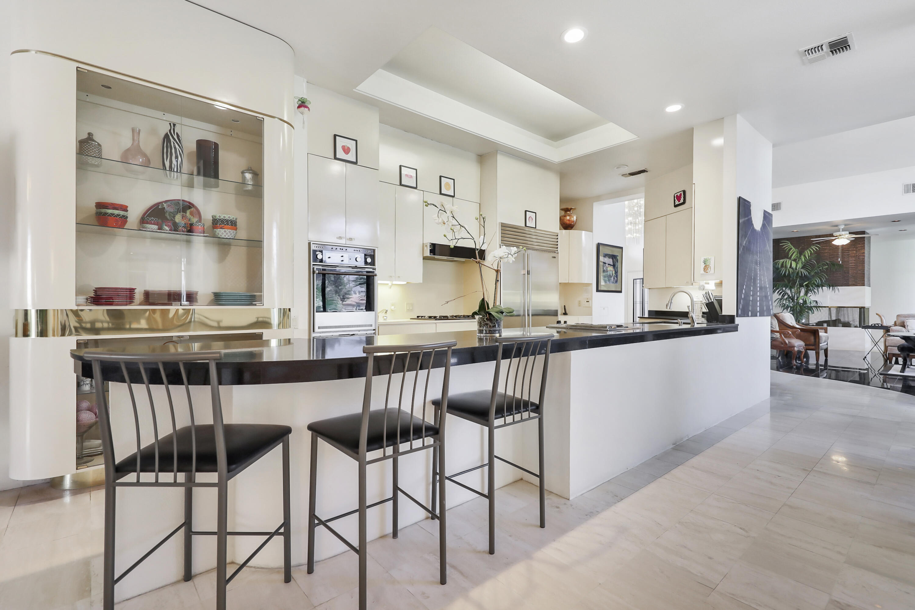 43721 Port Maria Road Bermuda Dunes, CA 92203 - Photo 4 of 37 a kitchen with stainless steel appliances kitchen island granite countertop a counter top space and furniture