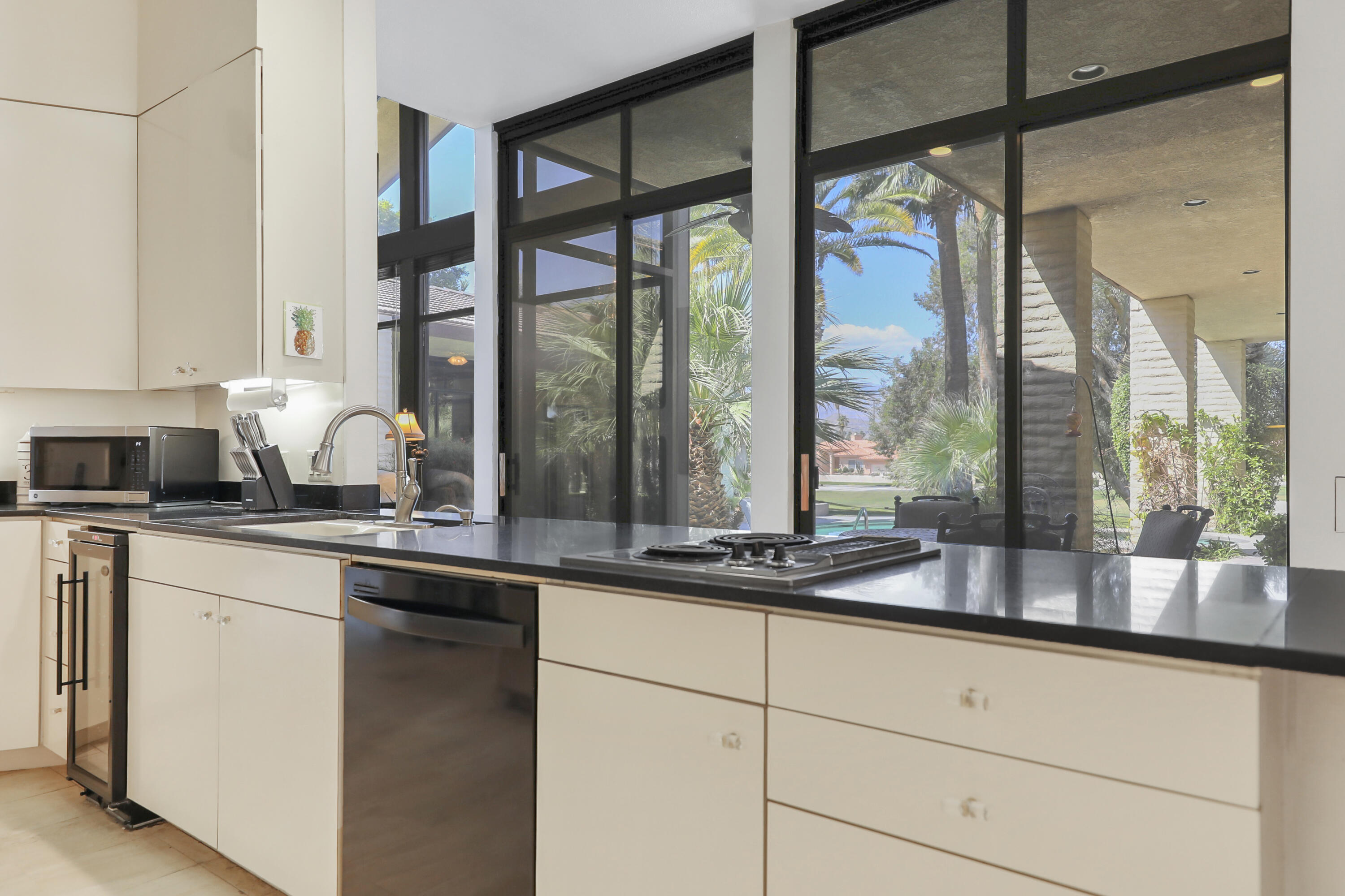 43721 Port Maria Road Bermuda Dunes, CA 92203 - Photo 5 of 37 a kitchen with granite countertop a large window and white cabinets