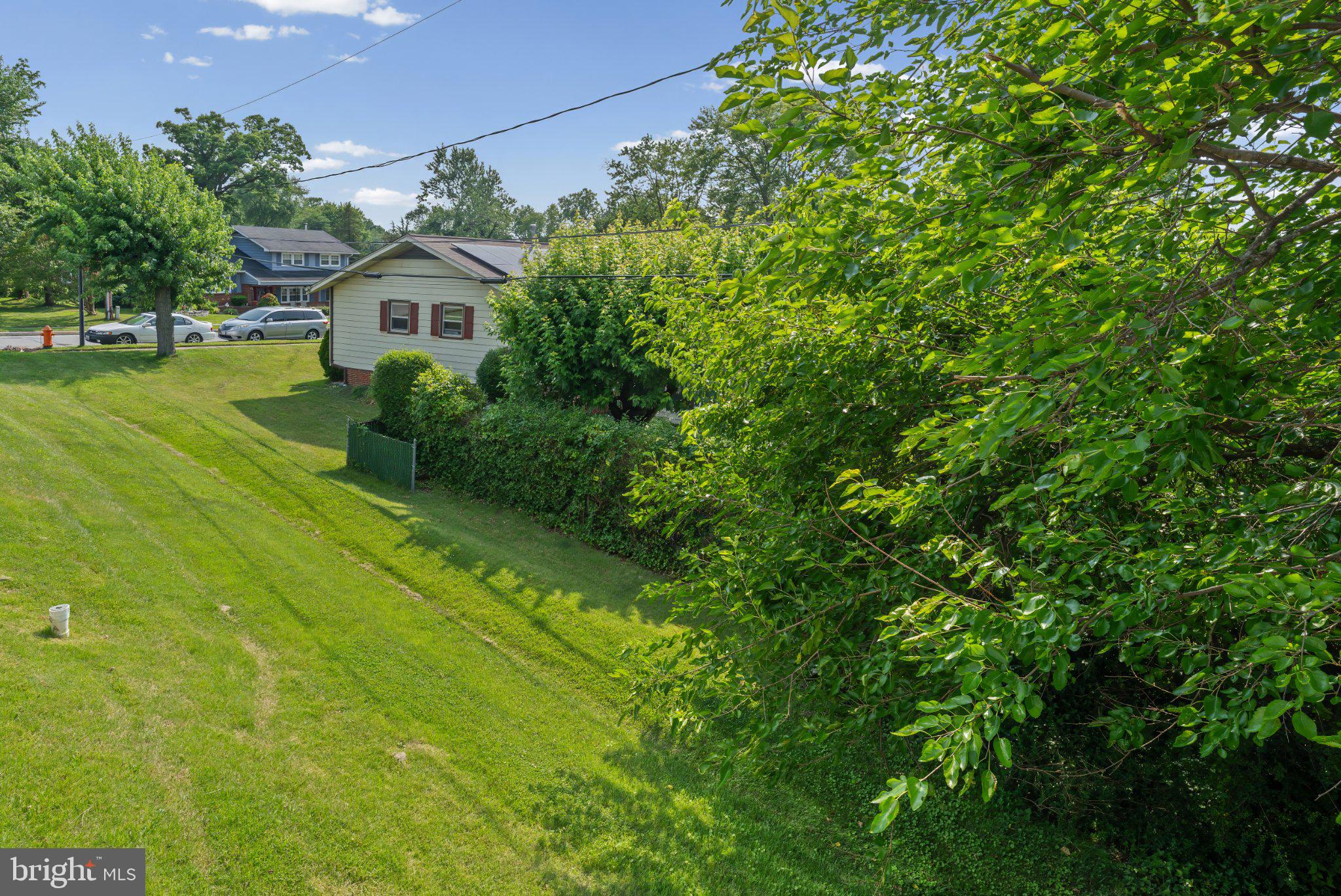 1317 Roxboro Road Baltimore, MD 21237 - Photo 30 of 30 Lush greenery surrounds a cozy home.