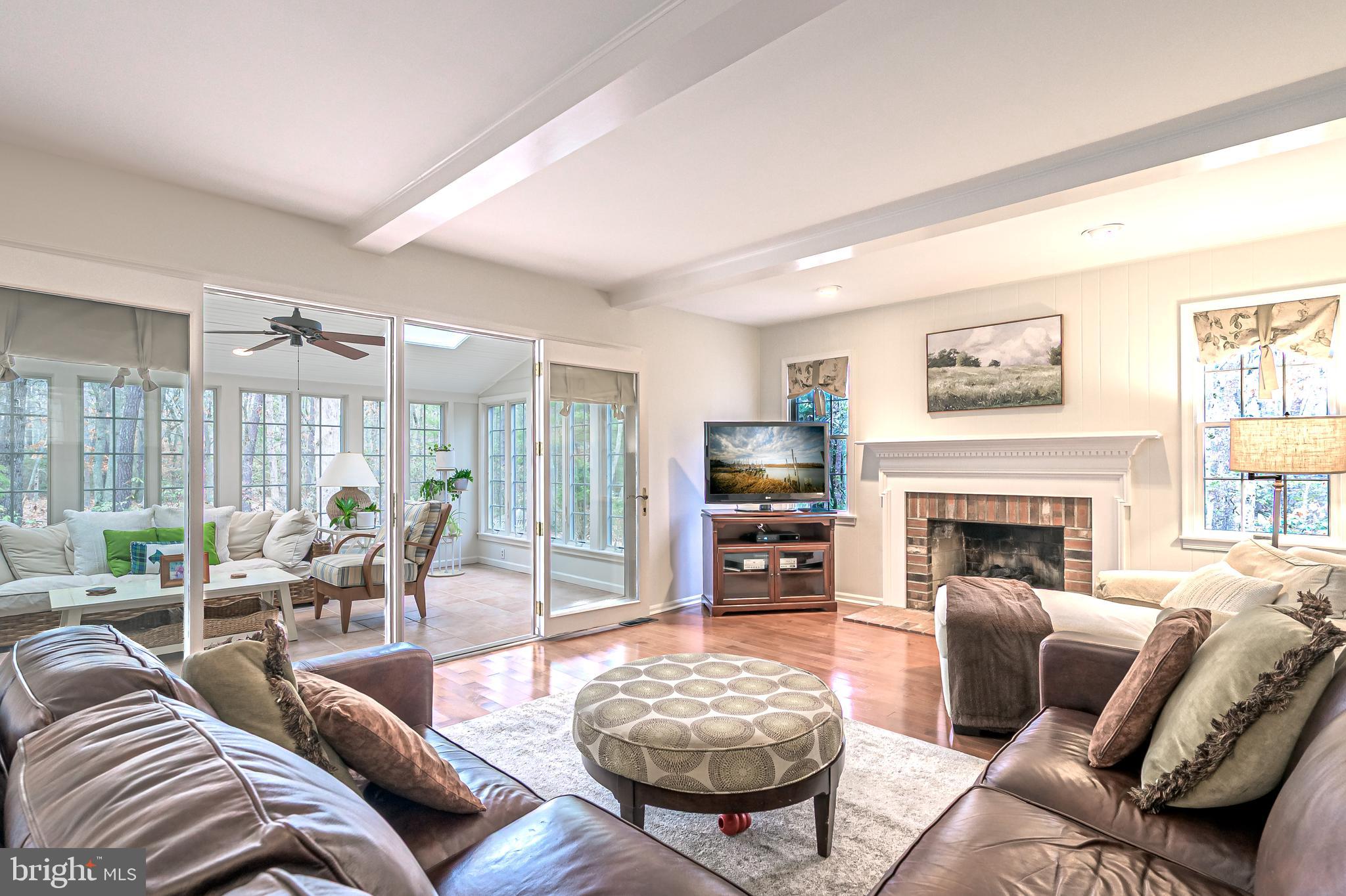 13 Pointe View Drive Medford, NJ 08055 - Photo 13 of 33 a living room with furniture a fireplace and a floor to ceiling window