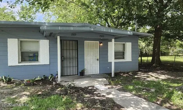 front view of a house with a tree