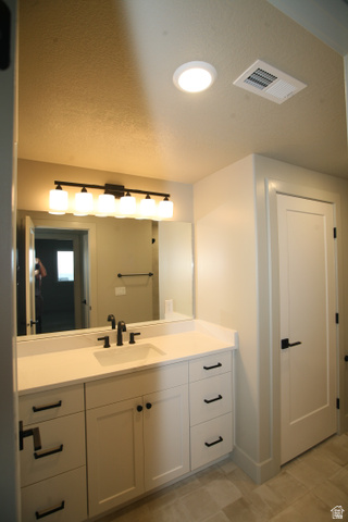 635 East Mountain Road North Ogden, UT 84414 - Photo 26 of 33 Modern bathroom vanity featuring white cabinetry with matte black hardware, a rectangular undermount sink, and a white countertop