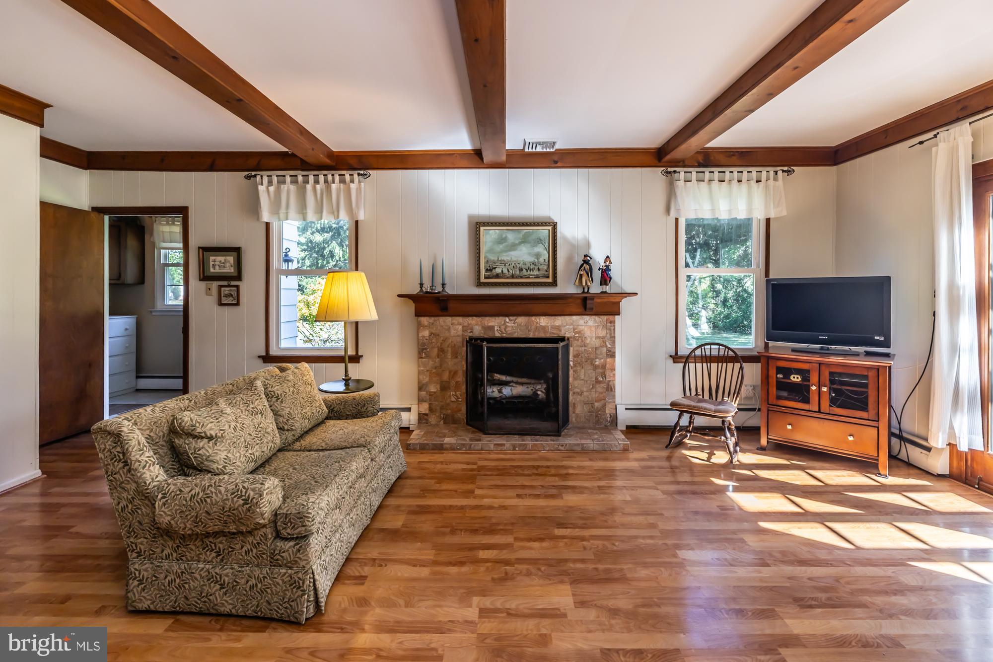 12 Flintshire Road Malvern, PA 19355 - Photo 23 of 50 a living room with furniture a flat screen tv and a fireplace