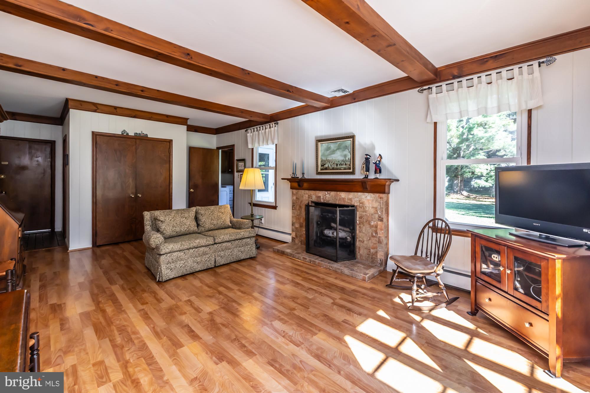 12 Flintshire Road Malvern, PA 19355 - Photo 24 of 50 a living room with furniture a flat screen tv and a fireplace