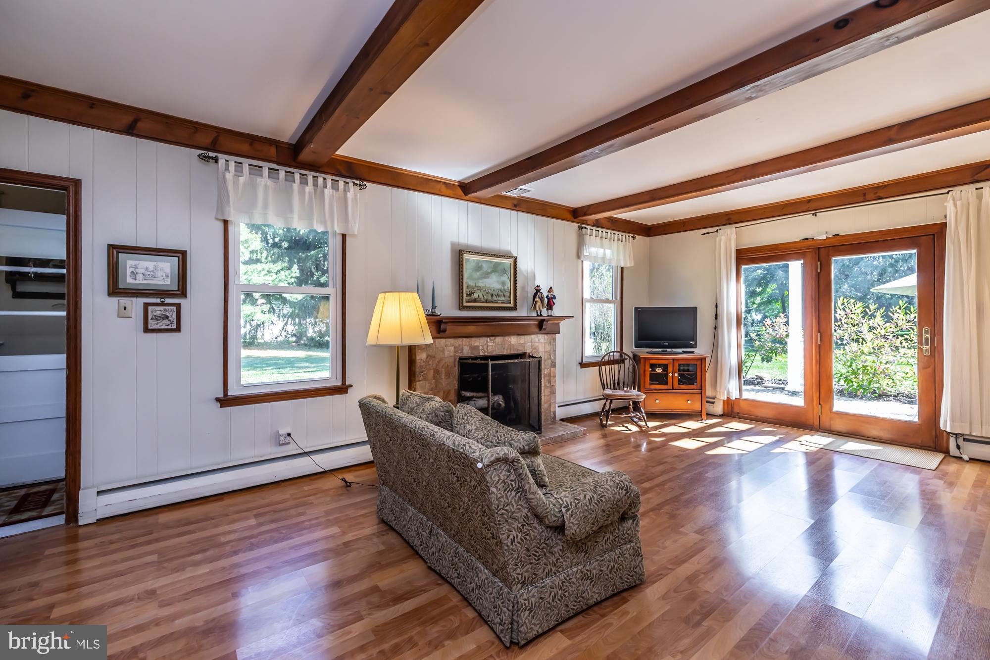 12 Flintshire Road Malvern, PA 19355 - Photo 25 of 50 a living room with furniture flat screen tv and a fireplace