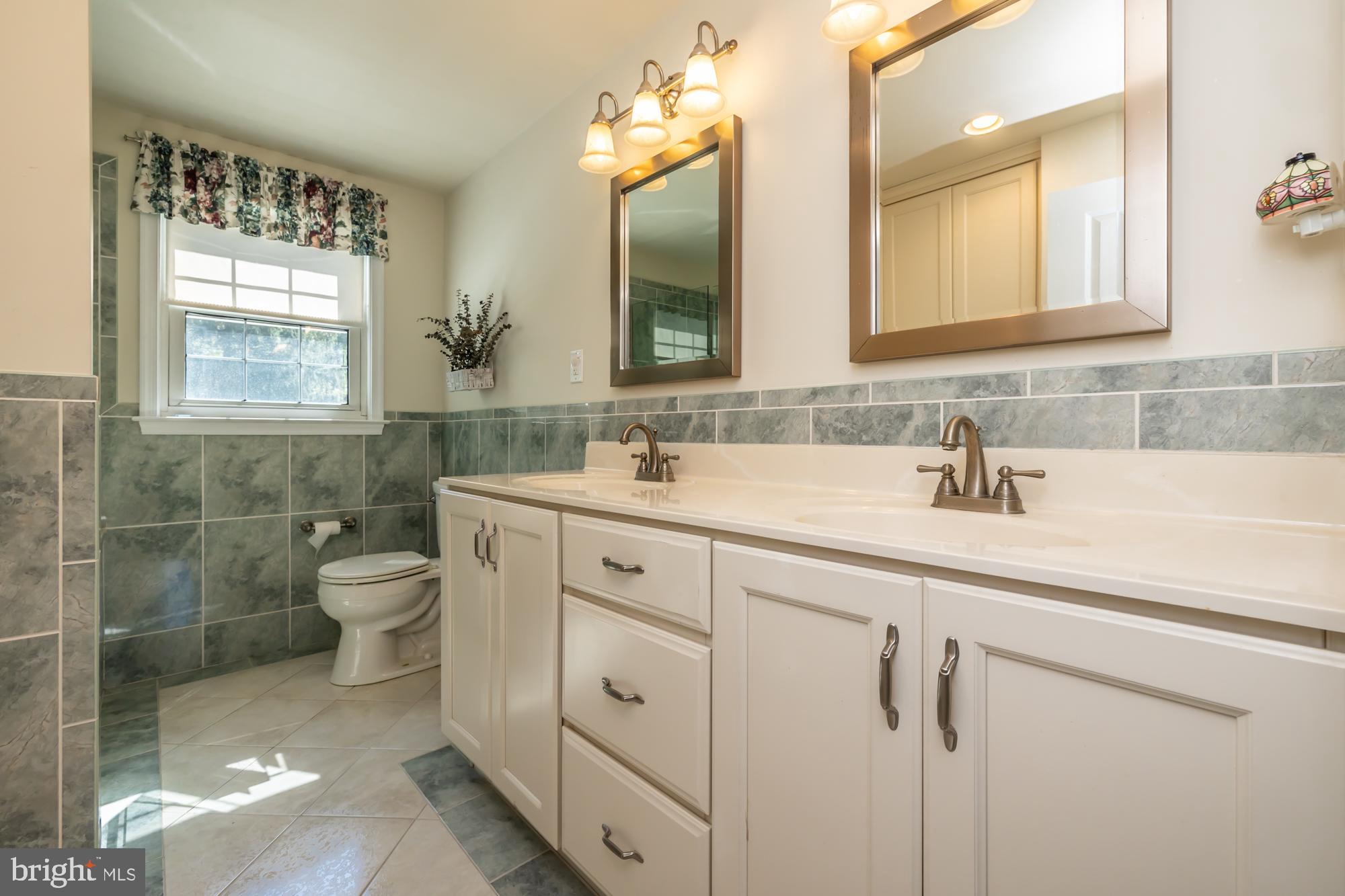 12 Flintshire Road Malvern, PA 19355 - Photo 34 of 50 a bathroom with a double vanity sink mirror and