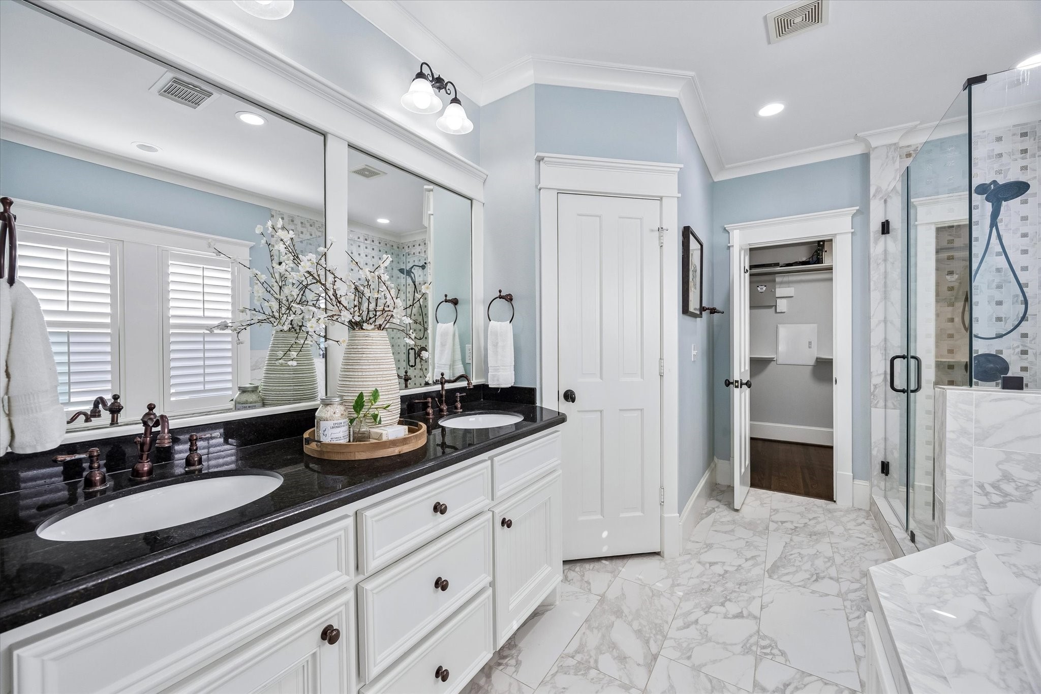 634 West 17th Street Houston, TX 77008 - Photo 19 of 42 Designed for relaxation, the primary bath is wrapped in elegant marble and granite finishes with a deep jetted soaking tub, a sleek walk-in shower, and a dual sink vanity with extensive storage.