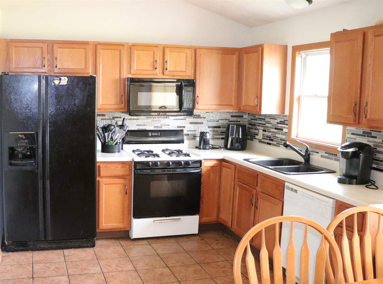 3950 Linden Road Rockford, IL 61109 - Photo 3 of 12 a kitchen with stainless steel appliances granite countertop a stove a sink and a refrigerator