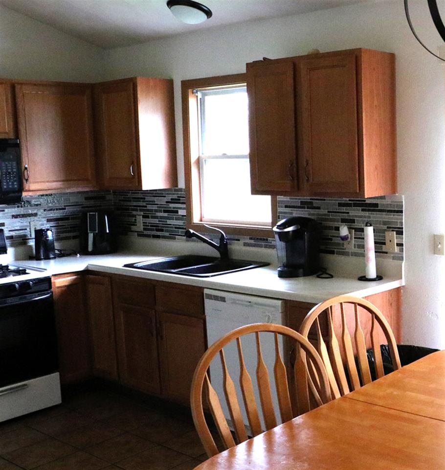 3950 Linden Road Rockford, IL 61109 - Photo 4 of 12 a kitchen with stainless steel appliances granite countertop a sink a stove a microwave cabinets and a dining table