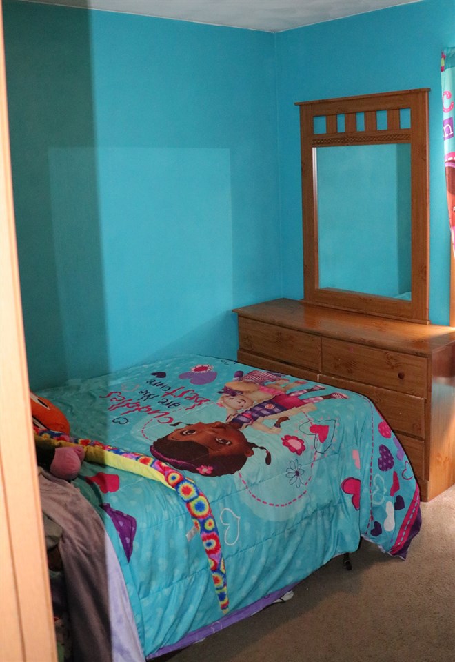 3950 Linden Road Rockford, IL 61109 - Photo 9 of 12 a bedroom with a bed and a dresser