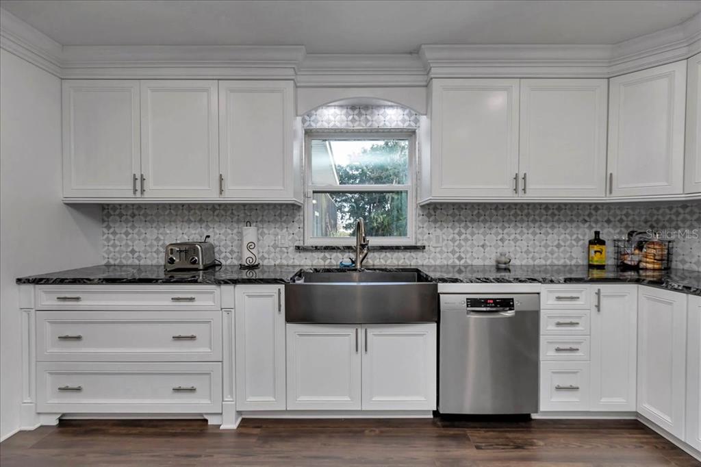 223 South Nesbitt Terrace Inverness, FL 34450 - Photo 18 of 85 a kitchen with granite countertop white cabinets and white appliances