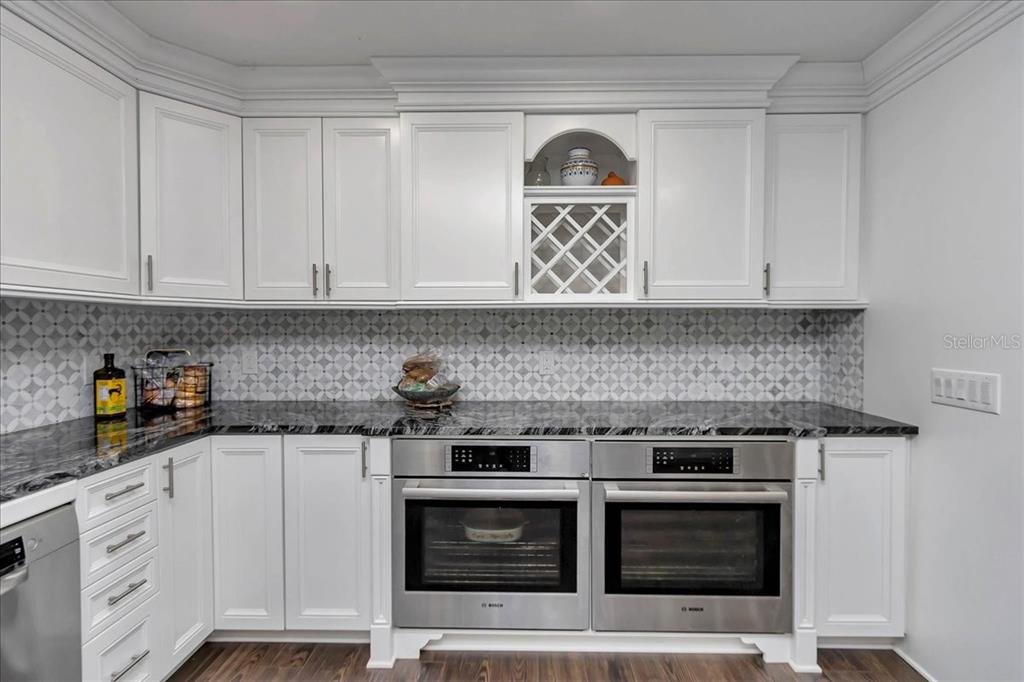 223 South Nesbitt Terrace Inverness, FL 34450 - Photo 20 of 85 a kitchen with stainless steel appliances granite countertop a stove and white cabinets