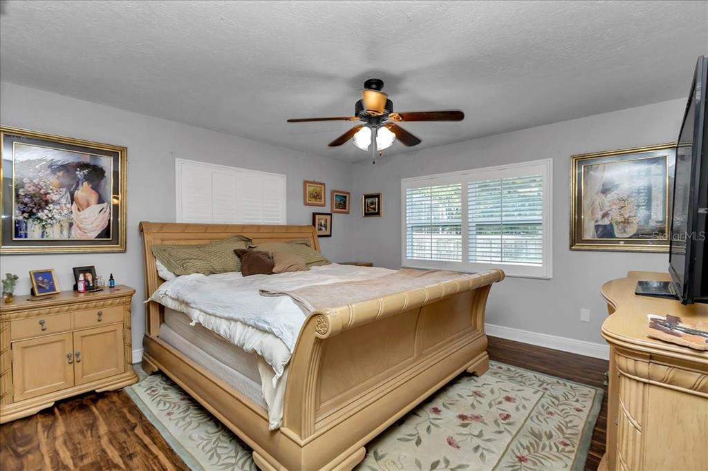 223 South Nesbitt Terrace Inverness, FL 34450 - Photo 34 of 85 a bedroom with a bed and a chandelier