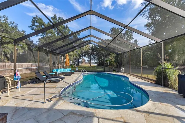 a aerial view of a house with table and chairs under an umbrella