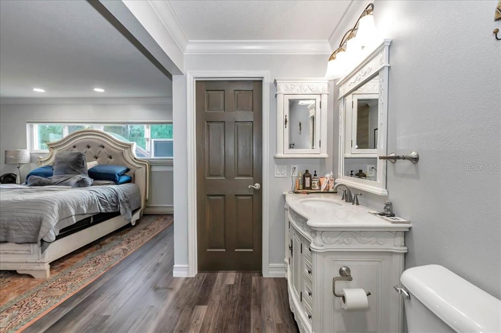 223 South Nesbitt Terrace Inverness, FL 34450 - Photo 42 of 85 a en suite bathroom with a sink and a large mirror