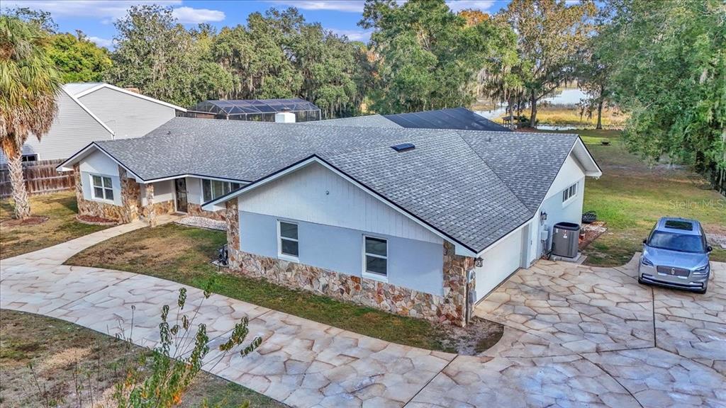 223 South Nesbitt Terrace Inverness, FL 34450 - Photo 6 of 85 a aerial view of a house with table and chairs under an umbrella