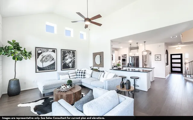 a living room with furniture and kitchen view