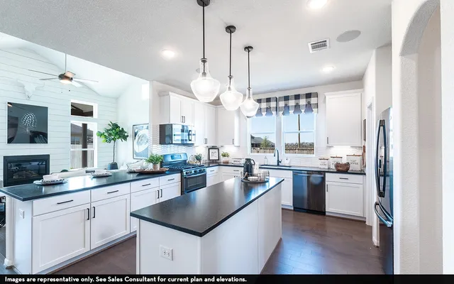 a kitchen with a sink stove and refrigerator