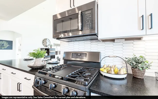 a kitchen with a stove and a microwave