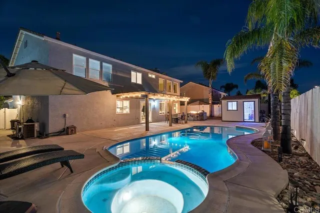a view of a swimming pool with outdoor seating