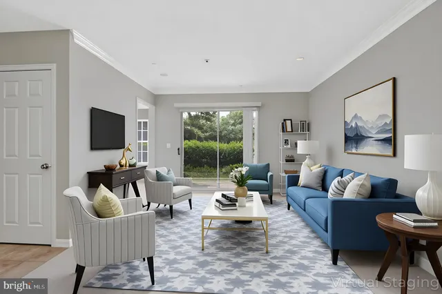 a living room with furniture flat screen tv and a large window