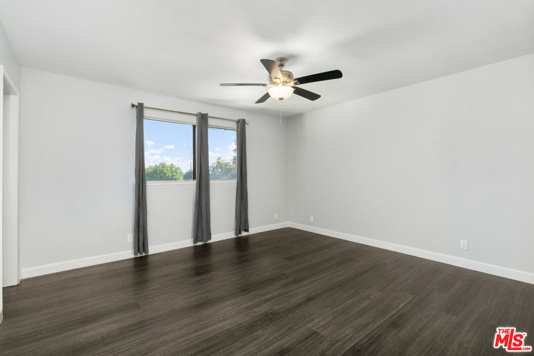 6703 Poinsettia Court Chino, CA 91710 - Photo 17 of 36 a view of an empty room with wooden floor and a window