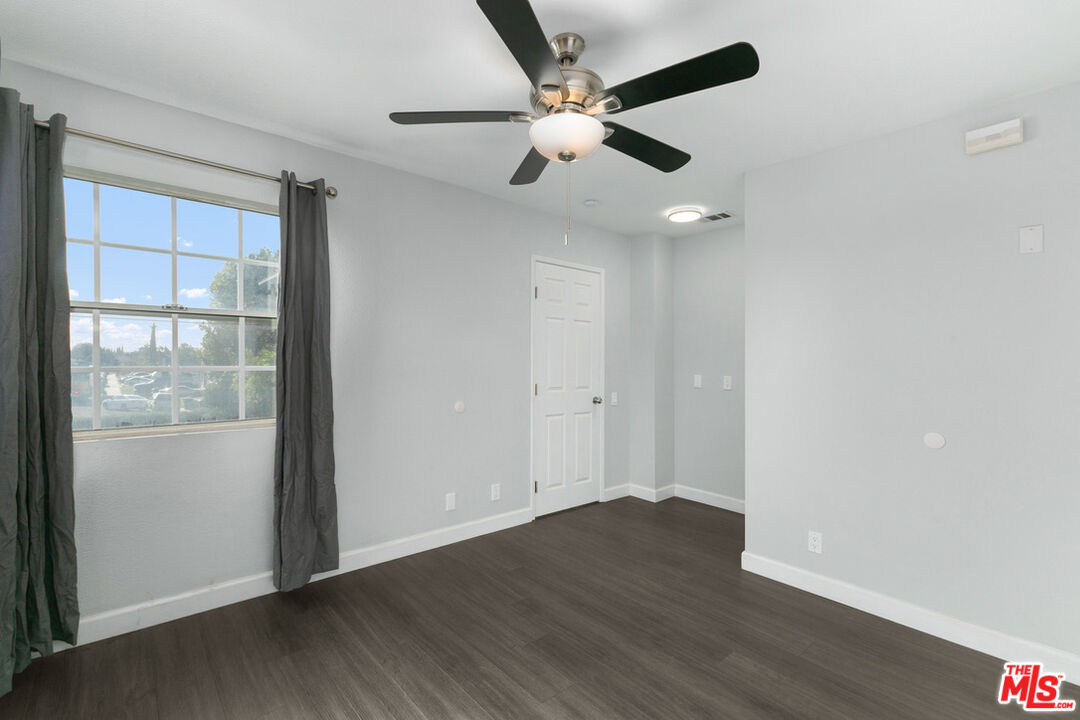 6703 Poinsettia Court Chino, CA 91710 - Photo 20 of 36 an empty room with wooden floor fan and windows