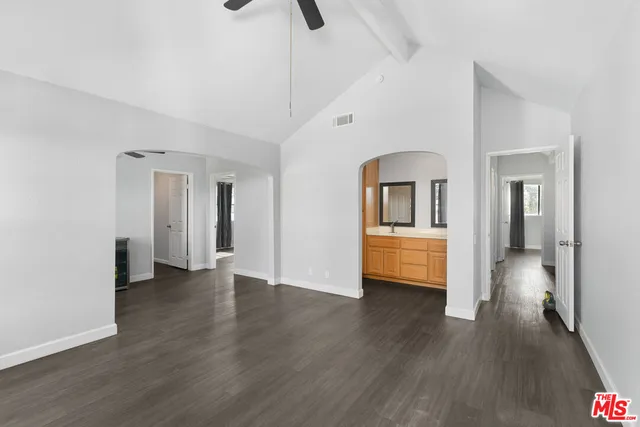 a view of a big room with wooden floor and cabinet