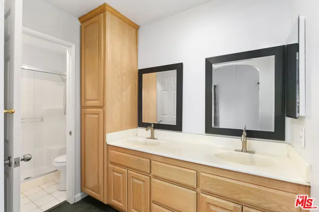a bathroom with 2 sink and a mirror