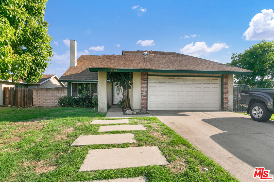6703 Poinsettia Court Chino, CA 91710 - Photo 27 of 36 a front view of a house with a yard and garage