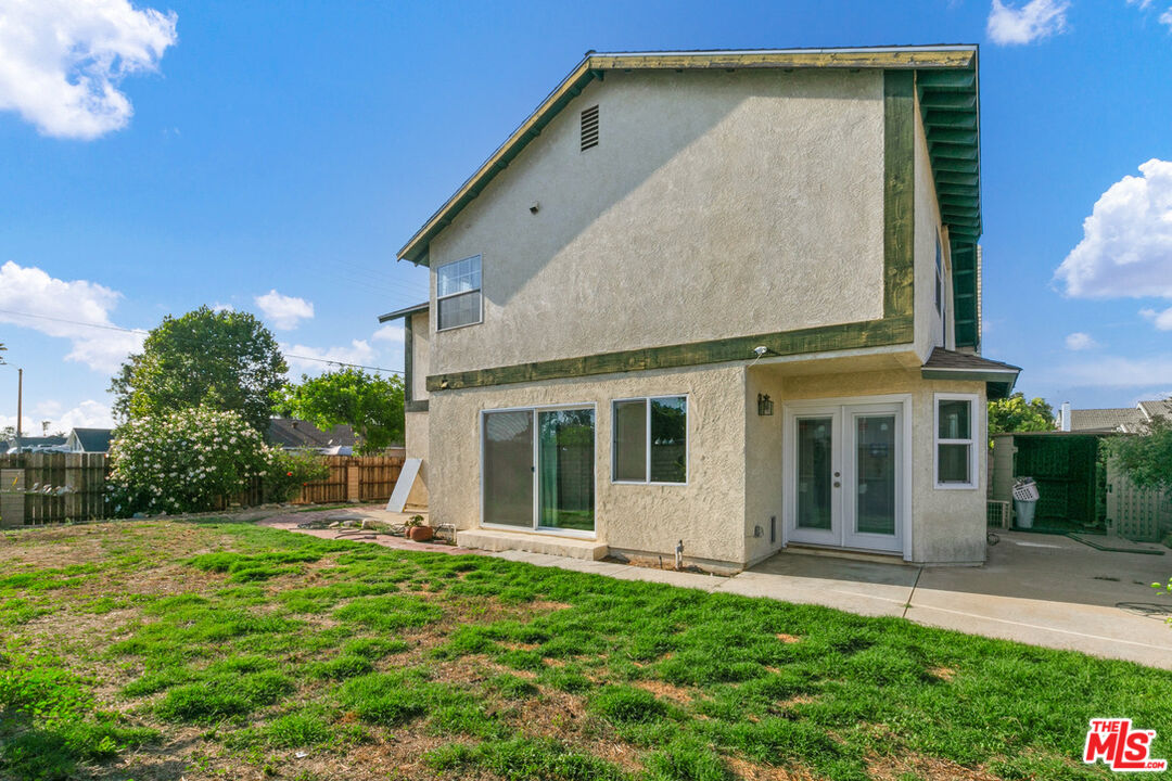 6703 Poinsettia Court Chino, CA 91710 - Photo 33 of 36 a view of a house with brick walls and a yard with potted plants