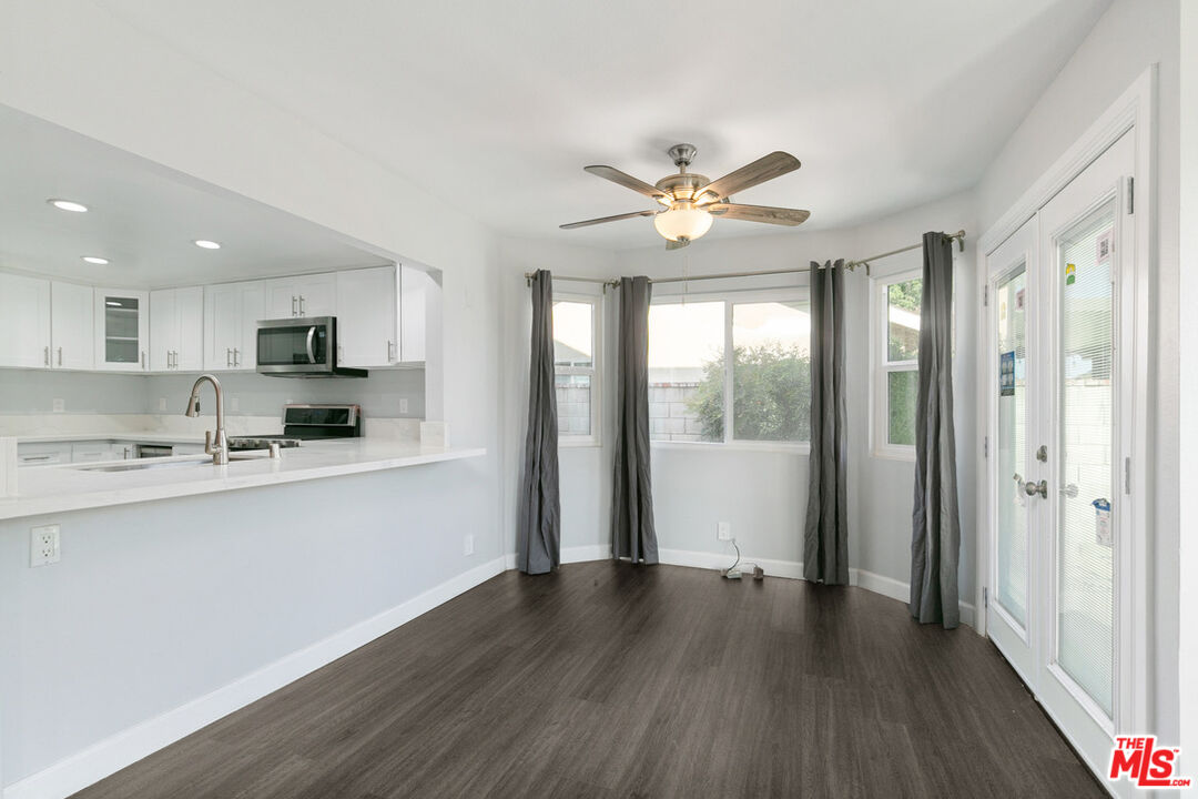 6703 Poinsettia Court Chino, CA 91710 - Photo 7 of 36 a view of a kitchen with a sink a ceiling fan and wooden floor