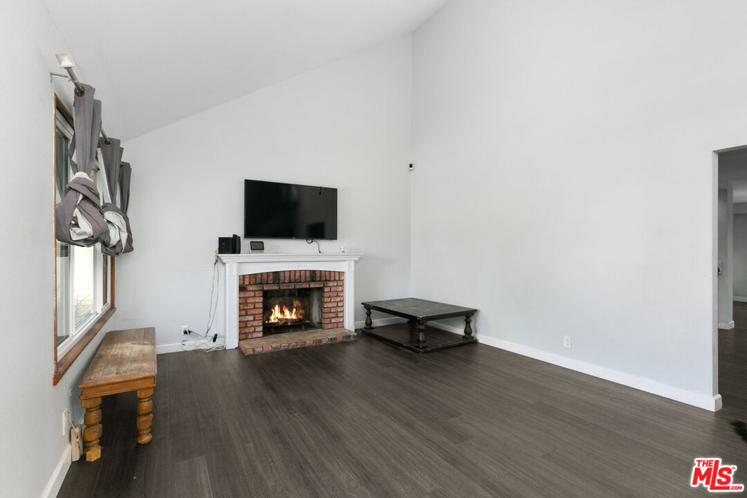 6703 Poinsettia Court Chino, CA 91710 - Photo 9 of 36 a living room with furniture a fireplace and a flat screen tv