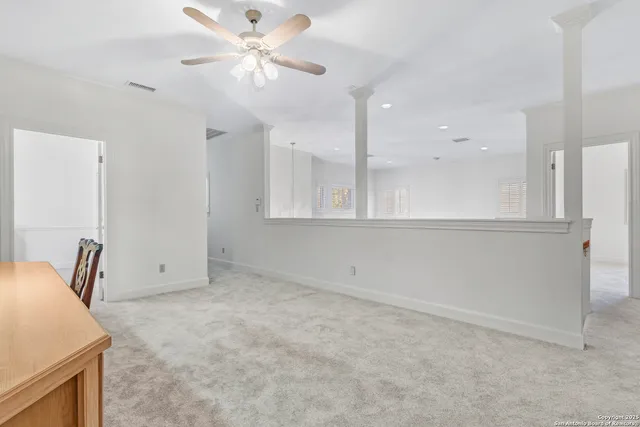 a bedroom with two beds and a chandelier