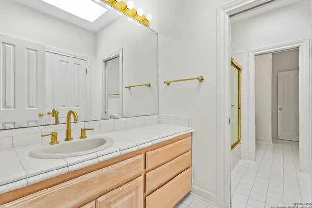 a bathroom with a shower and a sink