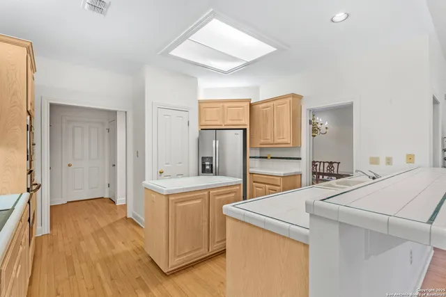 a kitchen with stainless steel appliances granite countertop a refrigerator sink and stove