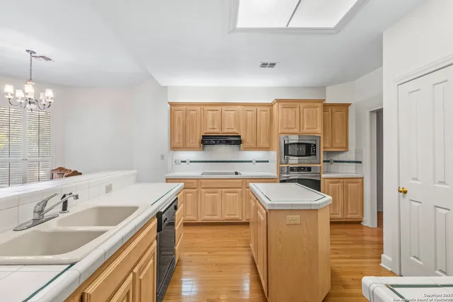 a dining room with furniture and a potted plant